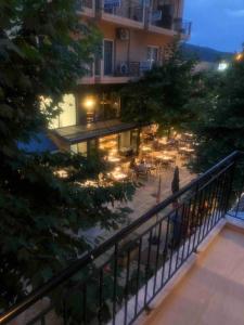 a person walking on a balcony of a building at night at Apartment MCS in Igoumenitsa