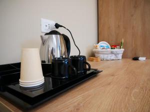 a coffee pot and cups sitting on a stove at B&B Civico 66 in Diamante
