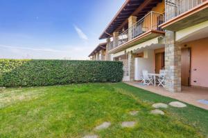 a backyard of a house with a hedge at Relax by the pool - Garden - Garage in Polpenazze del Garda