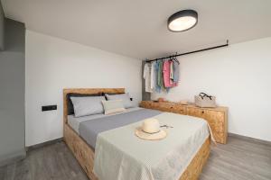 a bedroom with a bed with a hat on it at Loft 1 in Kos Town