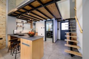 a kitchen with a counter and a staircase in a room at Loft 1 in Kos Town