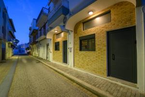 an empty street in an alley at night at Loft 1 in Kos Town