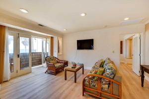 a living room with a couch and a tv at La Jolla Condo Rental Ocean View, Jetted Tub in San Diego