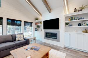 a living room with a couch and a tv at Town of Dewey Beach - 119 Jersey Street in Dewey Beach