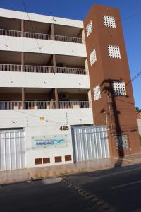 a building with a sign on the side of it at Pousada das Maracanãs in Maracanaú