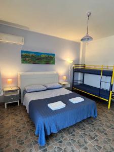 a bedroom with a bed and two bunk beds at Agriturismo Graziano e Barbara in Porto Conte