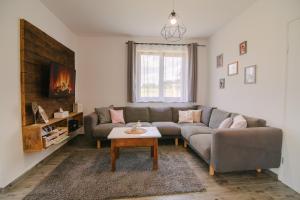 a living room with a couch and a table at Holiday house Daisy in Plaški