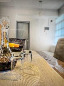 a bottle and two glasses sitting on a table at Diamond's House in Kallithea Halkidikis +13 photos