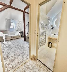 a hallway with a mirror and a living room at Hotel Kocour in Třebíč