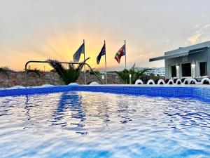 una piscina con banderas frente a una casa en Villa Agas, en Karterados