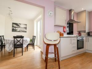a kitchen and dining room with a table and chairs at Number 37 in Bude