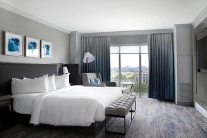 a hotel room with a large bed and a window at Franklin Marriott Cool Springs in Franklin
