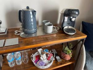 a coffee maker on a wooden table with a coffee maker at The Retreat in Doncaster