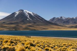 a group of people walking in front of a mountain at Our Habitas Atacama in San Pedro de Atacama