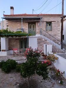 a stone house with a patio and stairs to it at a trip to the past and the beauty in Koumeika