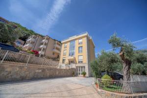 a building with a car parked in front of it at Apartments Bonazza in Petrovac na Moru