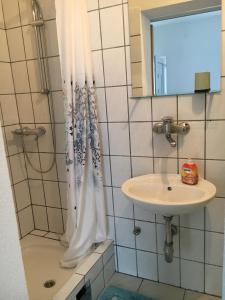a bathroom with a shower curtain and a sink at Top Location in Živogošće +32 photos