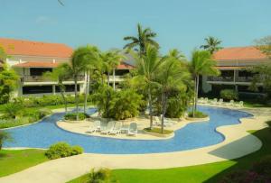 an aerial view of a resort with a swimming pool at Private Owned Suite at Coronado Luxury Suite Hotel & Golf Course in Playa Coronado