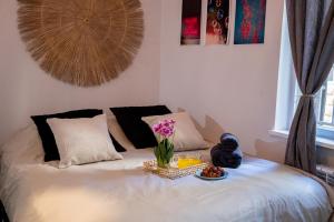 a bed with a tray of food and flowers on it at Haran in Jerusalem