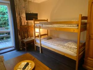 a room with two bunk beds and a table at Vital House in Kazimierz Dolny