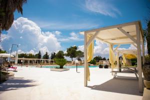 a pavilion at a swimming pool in a resort at Villa Conca Marco in Torre dell'Orso
