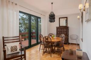 a dining room with a table and chairs at Matur I by An Island Apart in Água de Pena +32 photos
