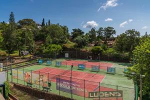 a tennis court with two tennis courts at Matur I by An Island Apart in Água de Pena