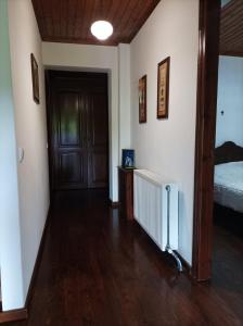 a room with a hallway with a bed and a door at House Christina in Palaioi Poroi