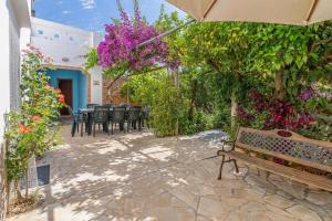 a patio with a bench and some plants and flowers at 4 bedrooms villa with private pool enclosed garden and wifi at Sant Miquel de Balansat 5 km away from the beach in Sant Miquel de Balansat