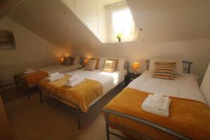a bedroom with two beds and a window in it at Lundwood House Barnsley by Smart Corporate Stays in Barnsley