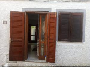 an open window of a building with brown shutters at Holiday house in Siniscola in Siniscola