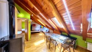 a kitchen with a table and chairs in a room at La buhardilla de Escarrilla - tucasaenlospirineos in Escarrilla