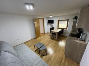 a living room with a couch and a table with a piano at Ferienwohnung Rener in Sautens