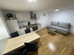 a kitchen and living room with a table and a couch at Ferienwohnung Rener in Sautens