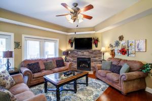 a living room with couches and a fireplace at Convenient Gatlinburg Condo in Gatlinburg