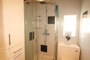 a shower with a glass door in a bathroom at Lundwood House Barnsley by Smart Corporate Stays in Barnsley +28 photos