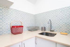 a kitchen with a sink and a red bag on the counter at Lisbon Hill House - NO. 589C in Lisbon