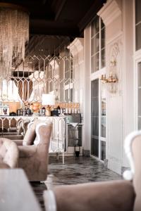 a living room with two couches and a kitchen at Hotel Aristocrat in Chernivtsi