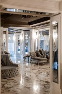 a living room with couches and a large mirror at Hotel Aristocrat in Chernivtsi