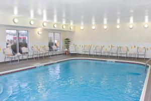 a large swimming pool with chairs and a table at Fairfield Inn & Suites by Marriott Memphis East Galleria in Memphis