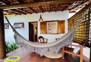 a hammock in the living room of a villa at Pousada Pandoro in Trancoso