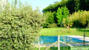 a fence next to a swimming pool in a yard at Domaine du Champ de l'Hoste in Larzac