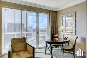 een woonkamer met een tafel en stoel en een groot raam bij MGM Signature-27-805 F1 Track & Strip View Balcony in Las Vegas