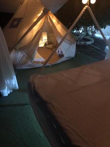 a close up of a tent with a bed inside at Camping Tents with Garden Hanging Bed in Porto Rafti