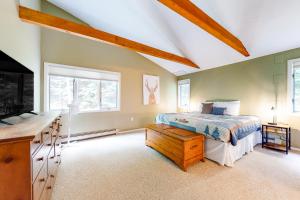 a bedroom with a bed and a tv and windows at Cow Hill Haven in Bartlett