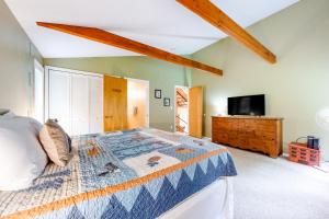a bedroom with a bed and a tv in a room at Cow Hill Haven in Bartlett