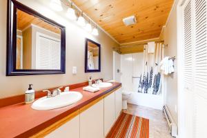 a bathroom with two sinks and a toilet at Cow Hill Haven in Bartlett +34 photos