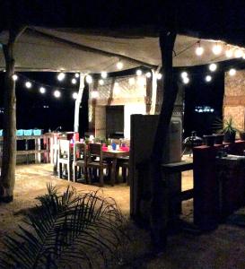 a tent with lights and tables and chairs at night at Sunset Paradise - Todos Santos in Todos Santos