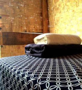 a bed with a blanket and a pillow on it at Sunset Paradise - Todos Santos in Todos Santos