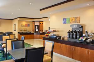 a restaurant with a bar with tables and chairs at Fairfield Inn & Suites by Marriott Memphis East Galleria in Memphis